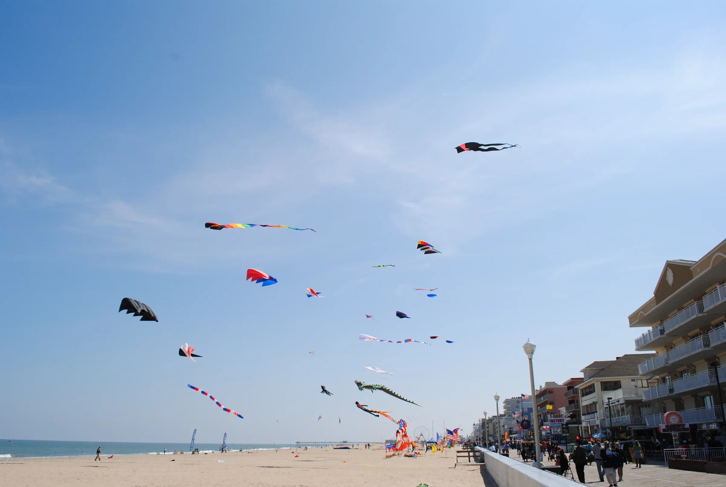 Visitors flying kites and enjoying the Ocean City Boardwalk in Maryland