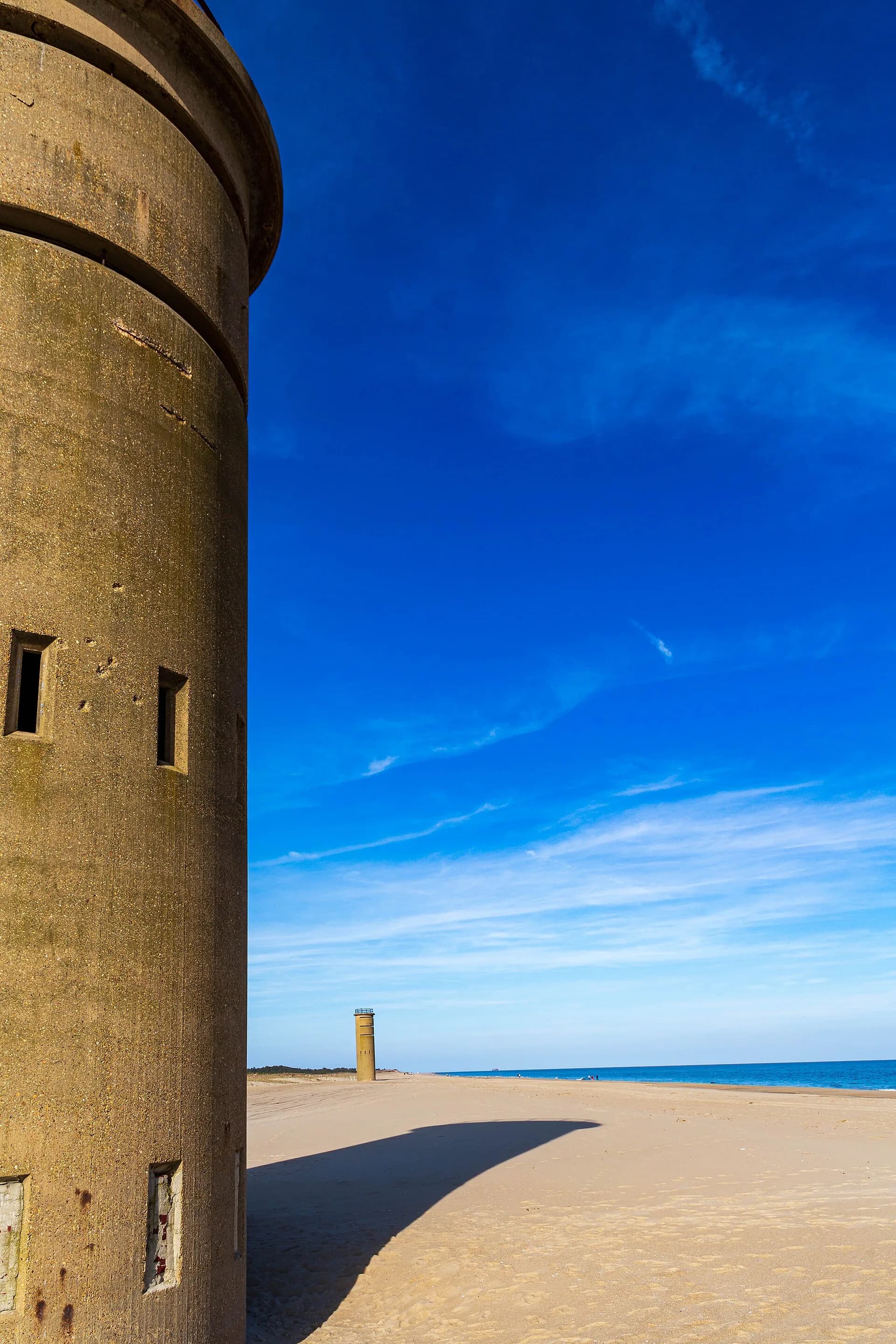 Wide-angle view of two World War II observation towers on the beach at Cape Henlopen, Delaware