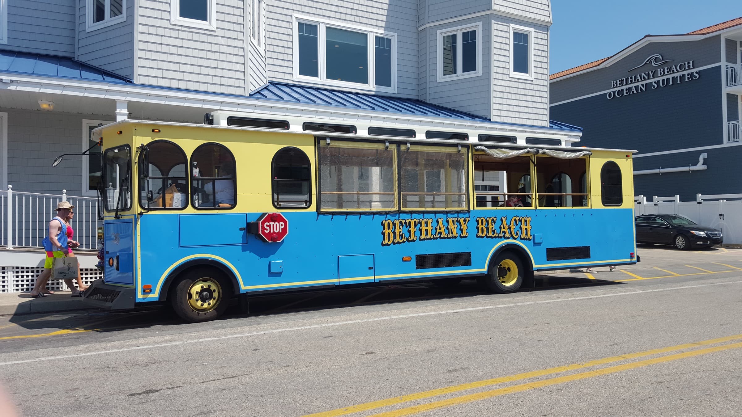 Blue-and-yellow Bethany Beach trolley parked outside Bethany Beach Ocean Suites