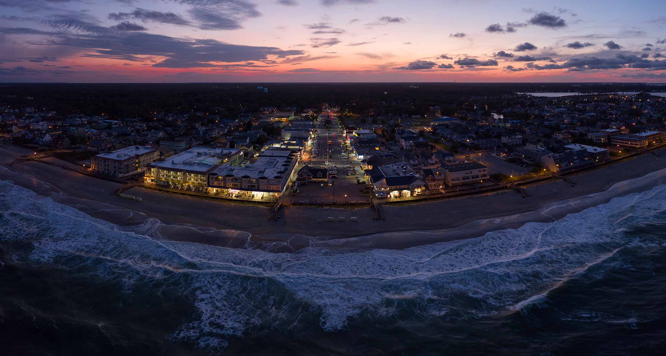 Bethany Beach boardwalk and shops illuminated at night