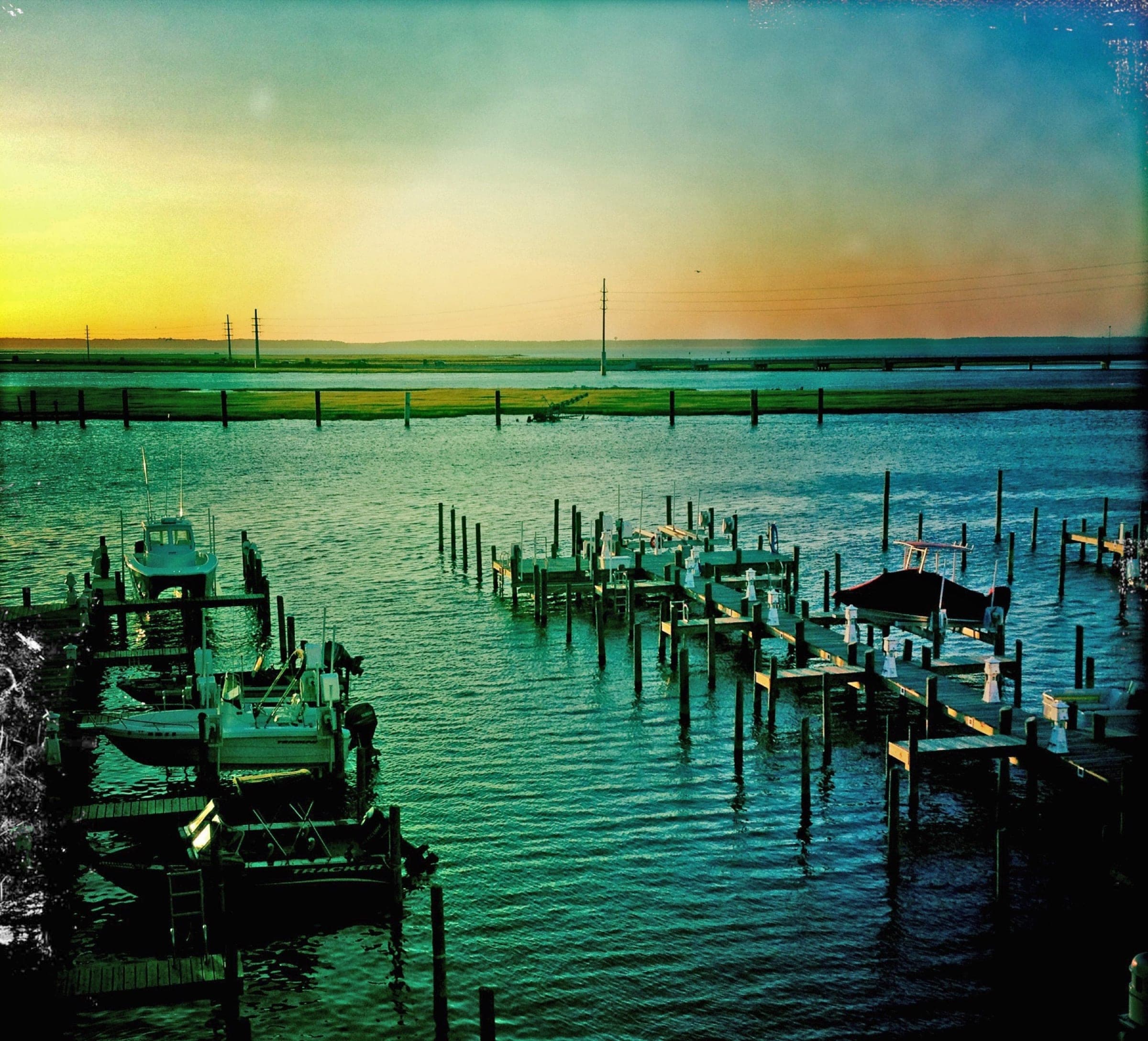 Boats and docks along Chincoteague Channel in evening light