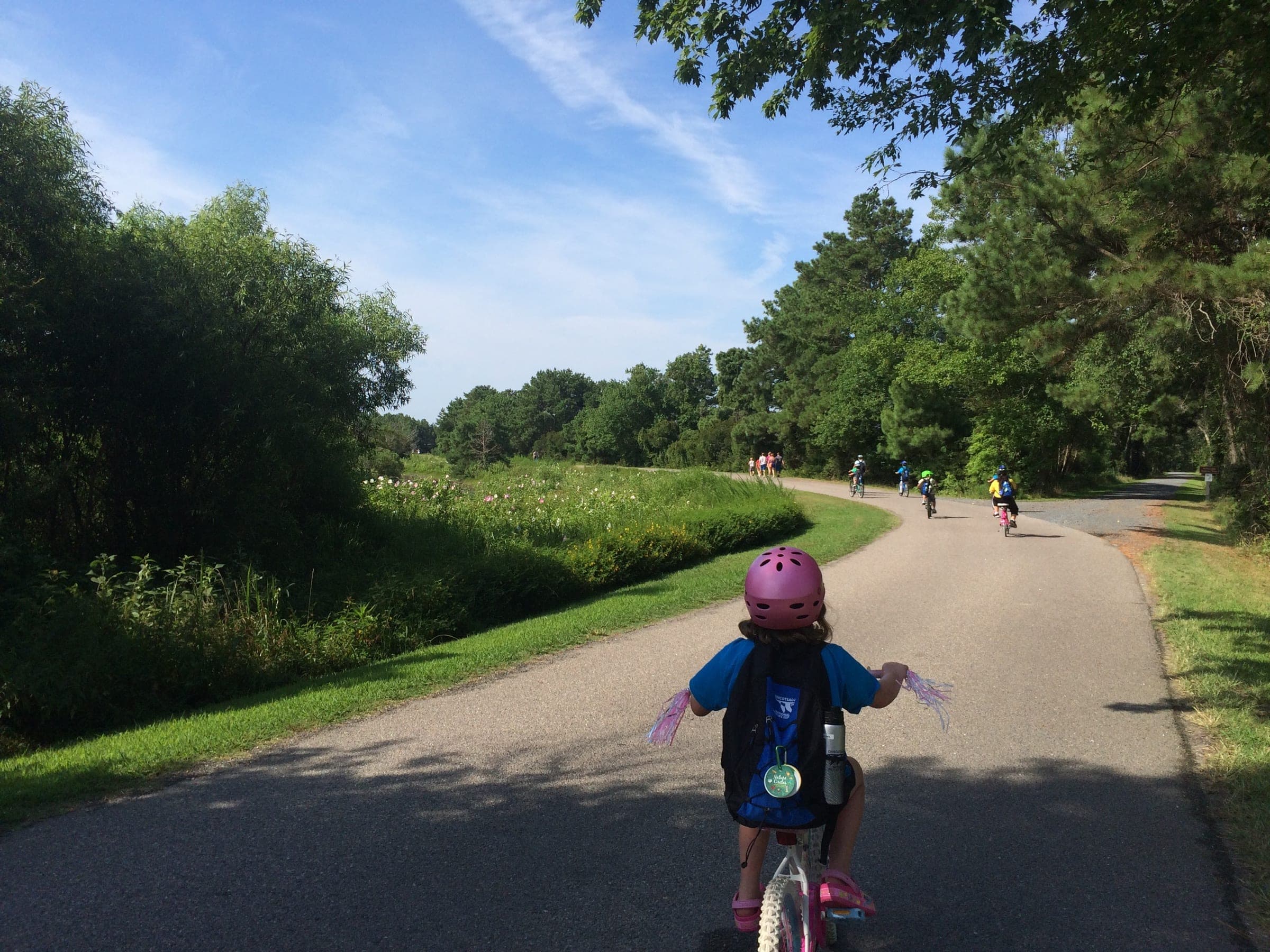 A child cycling along the Wildlife Loop at Chincoteague National Wildlife Refuge